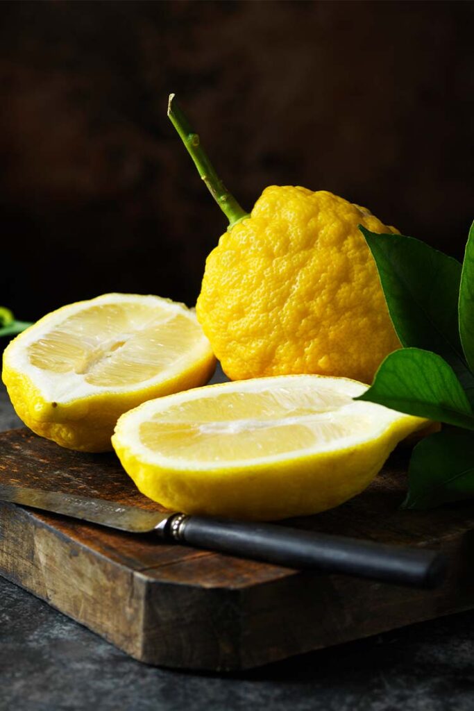 a lemons cut in half on a cutting board